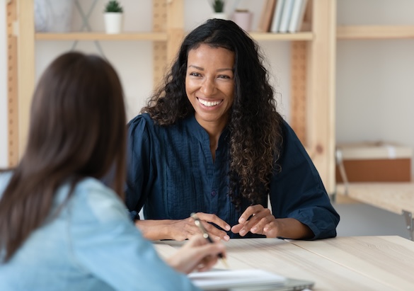Plano-United-Business-Featured Smiling young woman talk with female colleagues