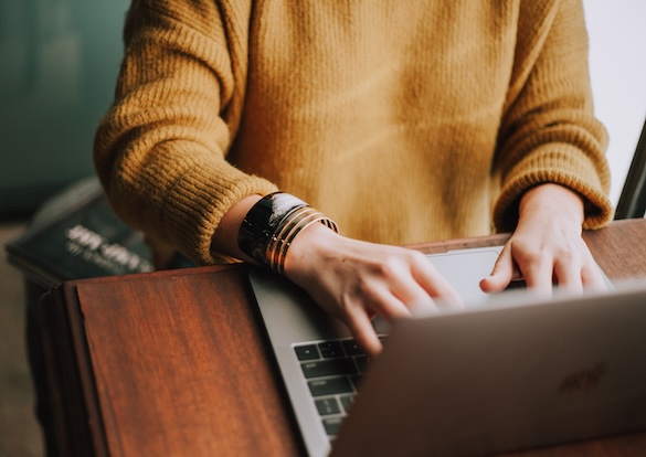 woman typing on a laptop